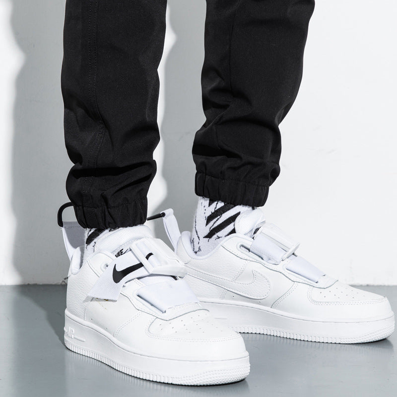 Mens Cotton Cropped Trousers in Black, close-up of the gathered ankle finishes styled with white trainers