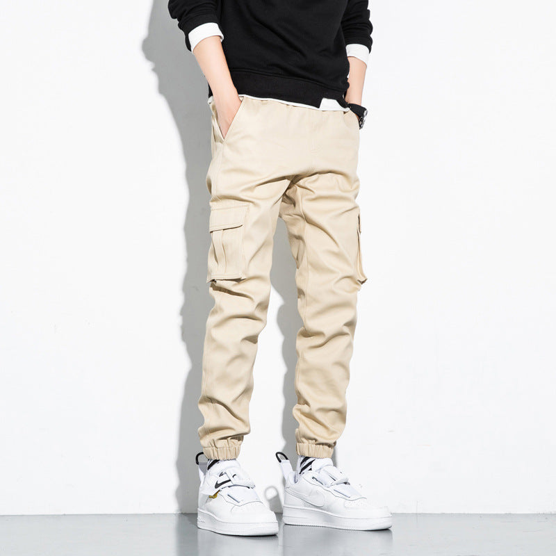 Mens Cotton Cropped Trousers in Khaki on a model, showing cargo-style side pockets and tapered legs