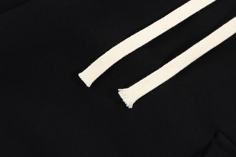 Mens Hip Hop Cotton Trousers in Black, close-up of the light-colored drawstring ends against the fabric