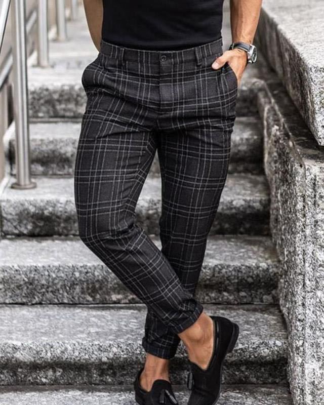 Mens Loose Fit Plaid Trousers in Black Plaid on a model, showing the tapered legs and checked pattern with black loafers