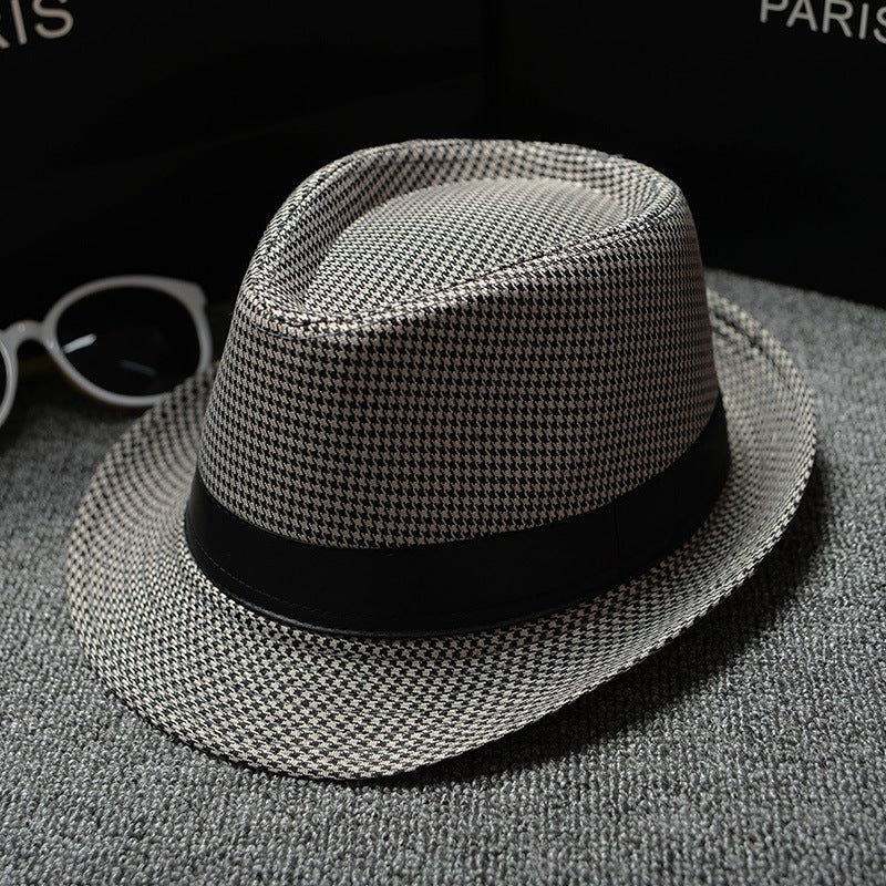 Mens Patterned Cotton Linen Hats in a light neutral houndstooth pattern with a black hatband, photographed on grey fabric