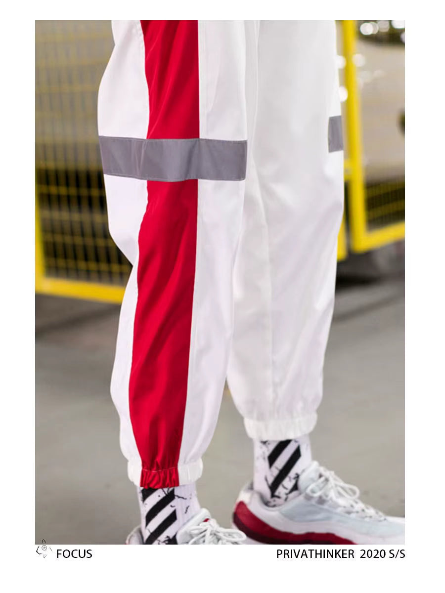 Mens Reflective Track Pants in White, close-up side view showing the red panel, reflective band and gathered ankle