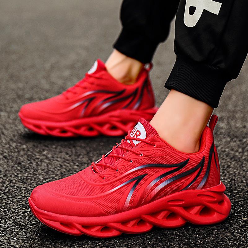 Mens Sculpted Sole Sneakers in red with black flame-inspired side accents and sculpted red soles, worn with black joggers.