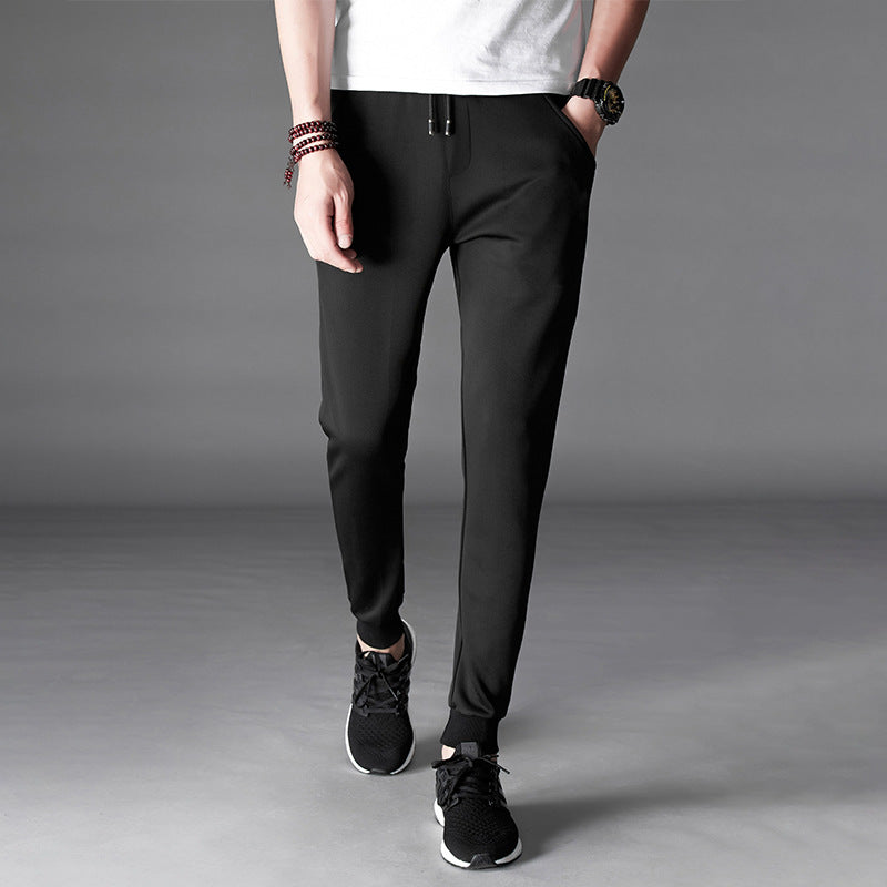 Mens Slim Fit Harem Pants in Black on a model, front view showing the slim silhouette and fitted ankle cuffs