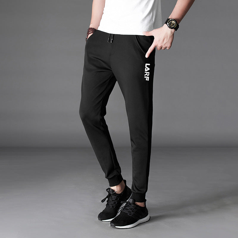 Mens Slim Fit Harem Pants in Black on a model, showing tapered legs and fitted ankle cuffs