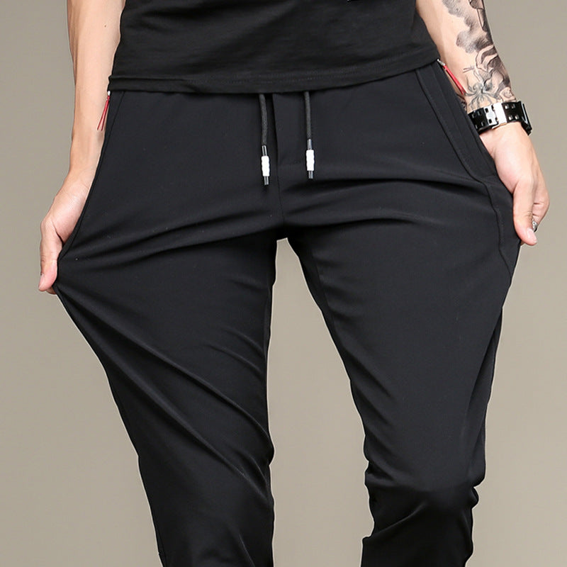 Mens Slim Fit Trousers in black styled with a dark knit sweater and athletic sneakers