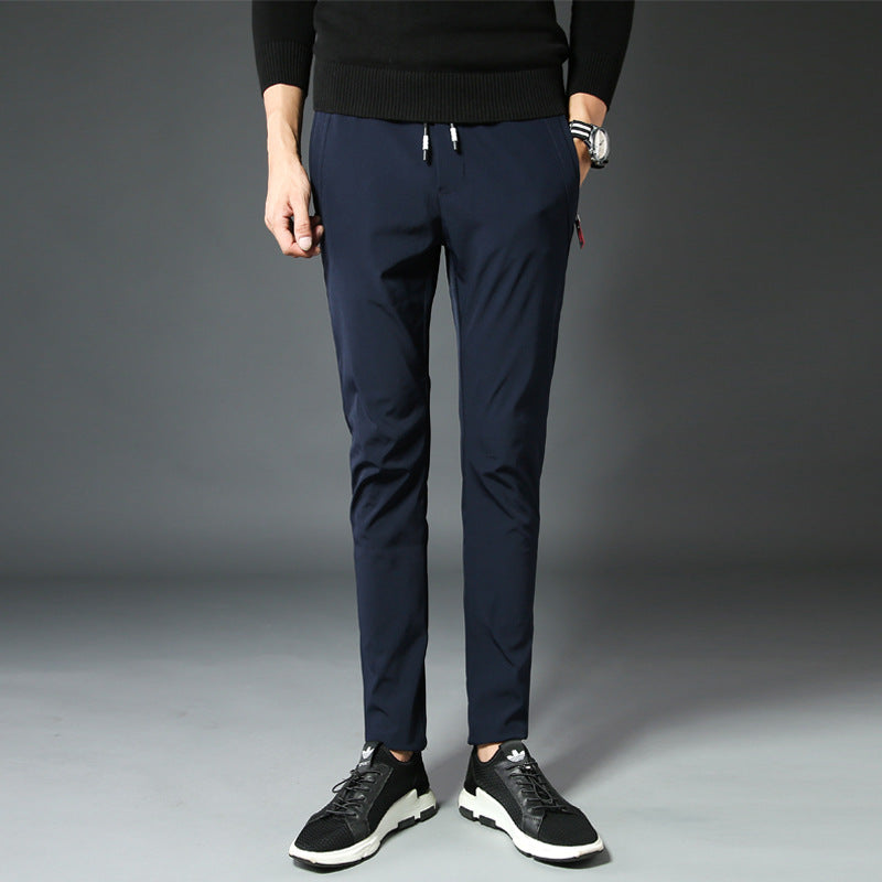 Mens Slim Fit Trousers in black styled with a dark knit sweater and athletic sneakers