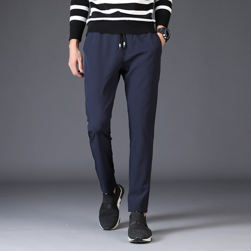 Mens Slim Fit Trousers in royal blue styled with a striped sweater and black sneakers