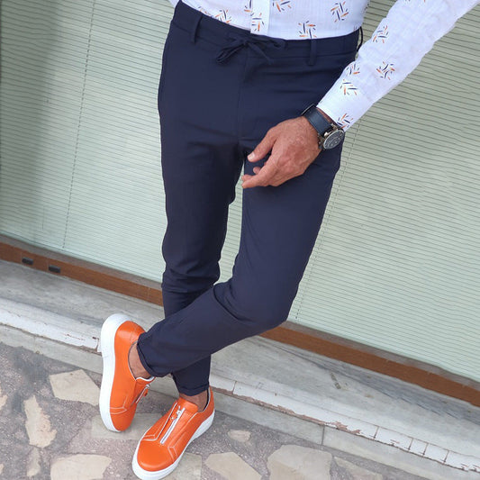 Mens Straight Casual Trousers in navy blue, close view of a model wearing a patterned shirt and orange trainers