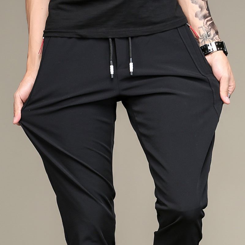 Mens Thick Stretch Trousers in Black on a model stretching the fabric outward at the thighs