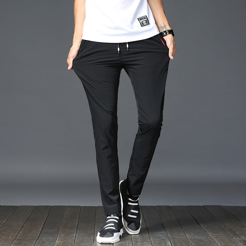Mens Thick Stretch Trousers in Black on a standing model with hands in the pockets, showing the slim silhouette