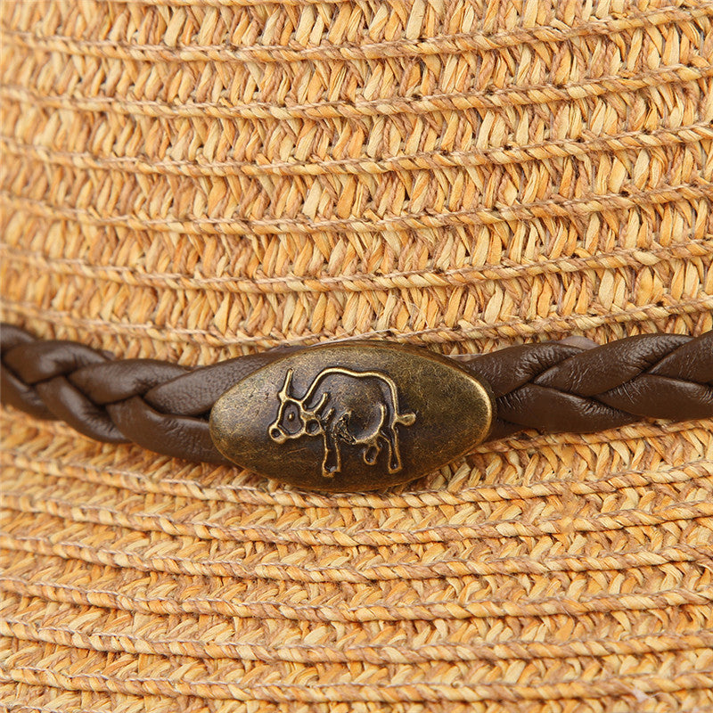 Unisex Cowboy Sun Hat close-up showing the golden-brown woven material, braided hatband and oval decorative ornament