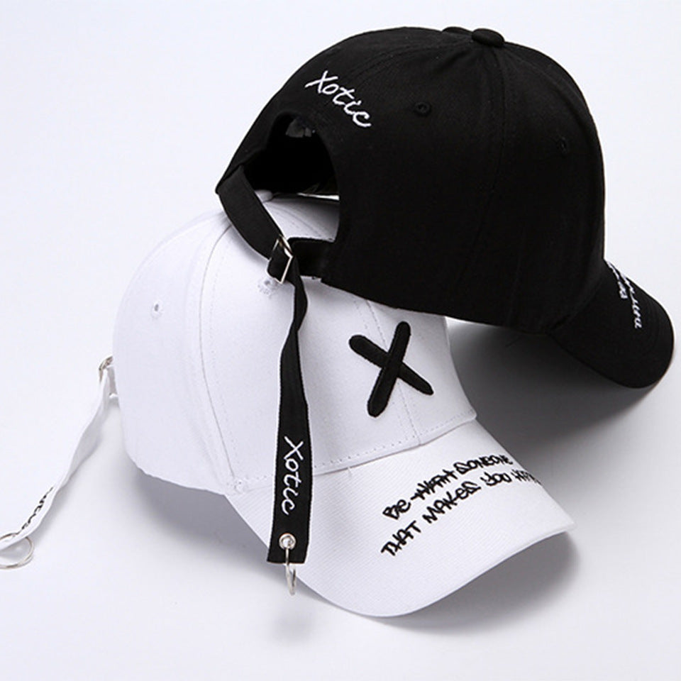 Unisex Embroidered Baseball Cap in black and white, stacked to show X embroidery, peak lettering and long adjustment straps.