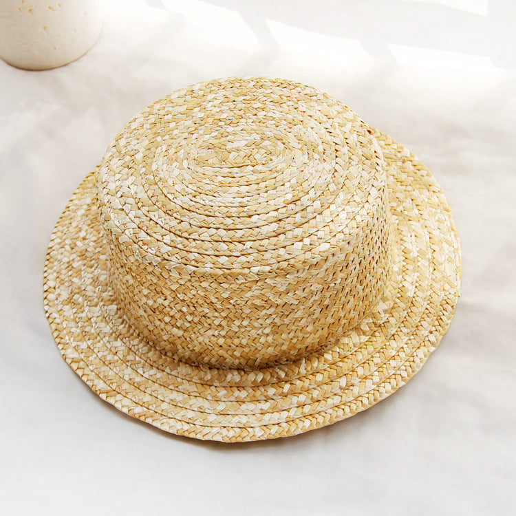 Womens Boater Straw Hat in natural straw tones with a flat crown, plain woven finish and short brim.