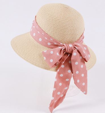 Womens Bow Sun Hat in beige with a pink ribbon bow featuring white polka dots, a rounded crown and curved brim.