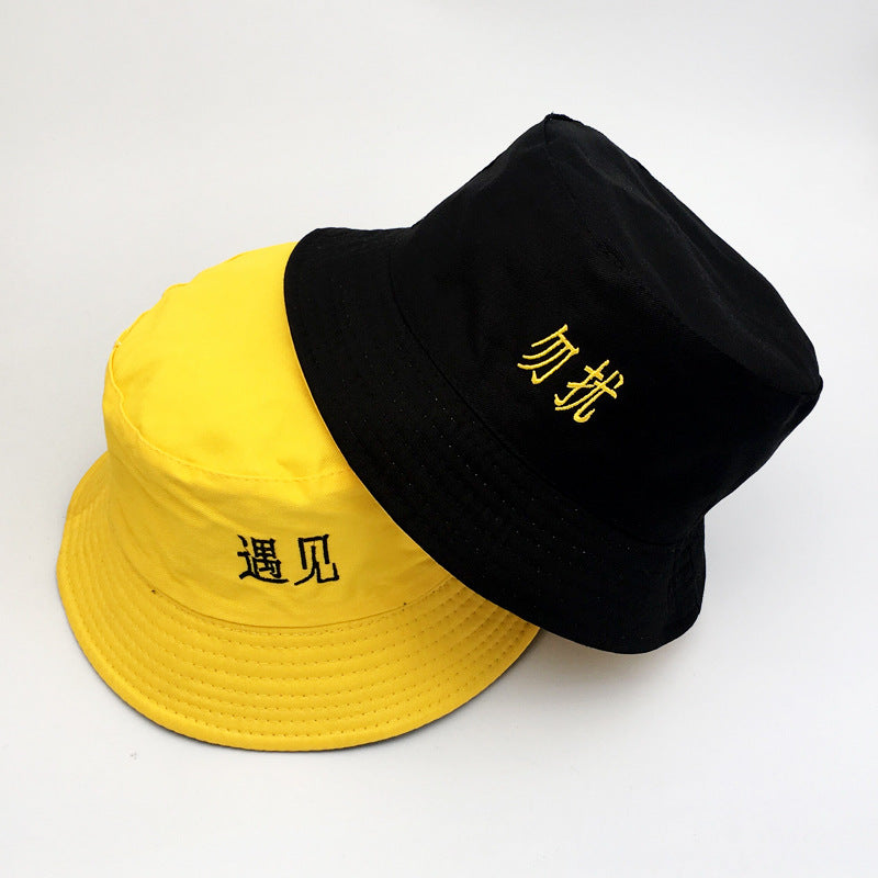 Womens Embroidered Bucket Hat shown in yellow and black with contrasting embroidered Chinese lettering.