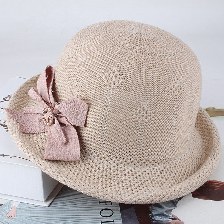 Womens Floral Knit Sun Hat in beige with floral texture, a curled brim and a dusty pink decorative bow.