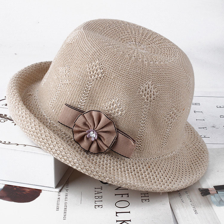 Womens Floral Knit Sun Hat in beige with floral texture and a taupe rosette and ribbon decoration.