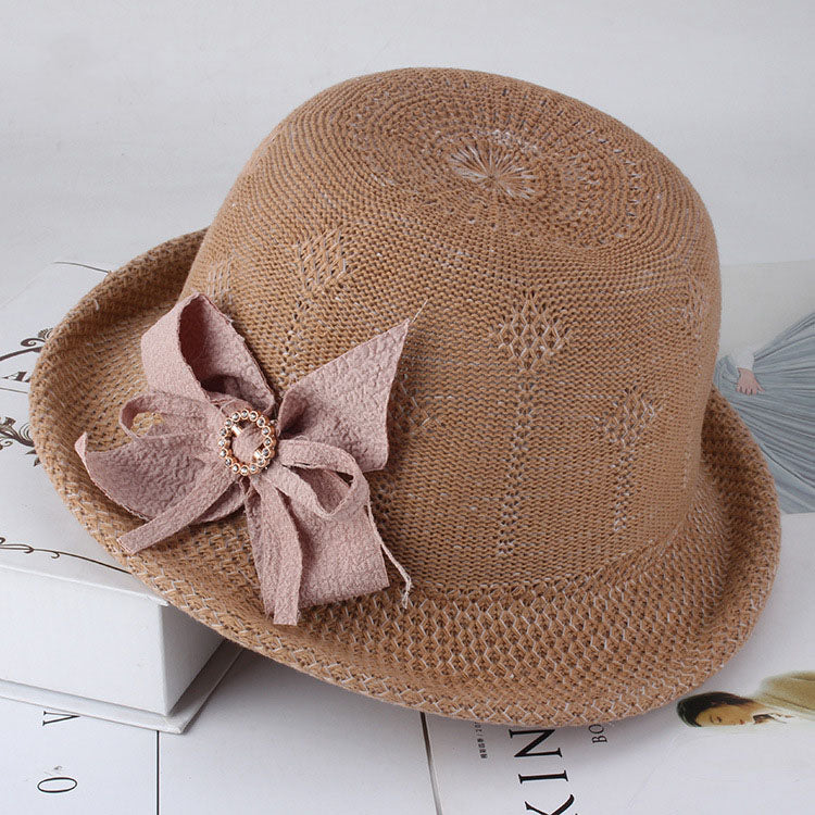 Womens Floral Knit Sun Hat in brown with a floral openwork pattern, curled brim and large dusty pink bow with a circular centre detail.