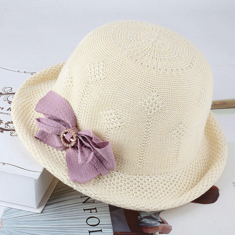 Womens Floral Knit Sun Hat in cream with a floral openwork pattern and a contrasting mauve bow.