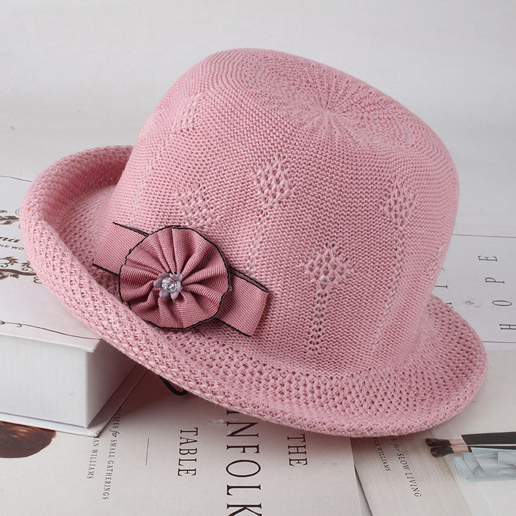 Womens Floral Knit Sun Hat in pink with a textured floral pattern and a small matching rosette decoration.