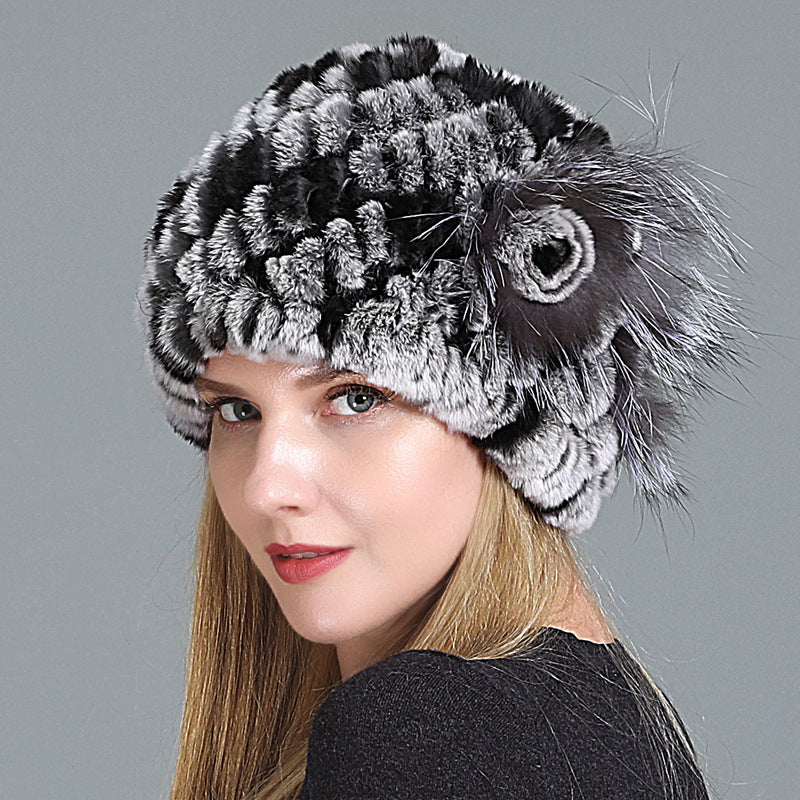Womens Fur Knitted Hat in black and grey with contrasting textured rows and a decorative side flower.