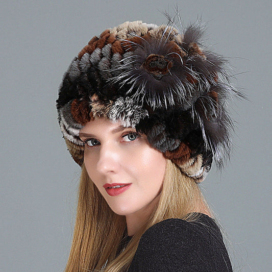 Womens Fur Knitted Hat in brown, black and grey tones, worn by a model with a decorative side flower.