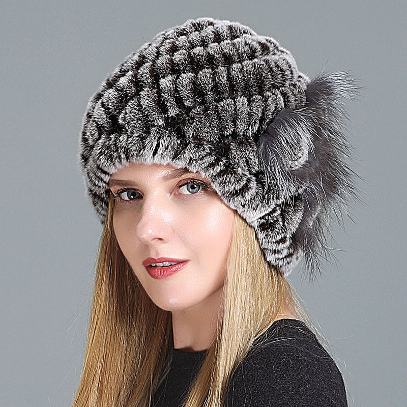 Womens Fur Knitted Hat in grey with dark accents, textured rows and a grey decorative side flower.