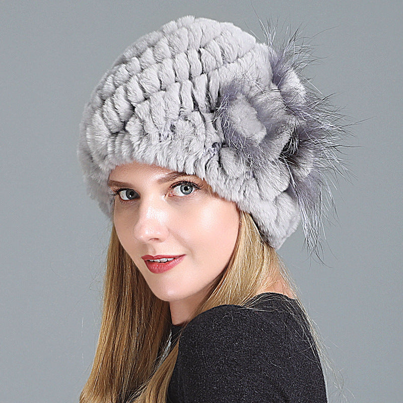 Womens Fur Knitted Hat in light grey with a matching decorative side flower, worn by a model.