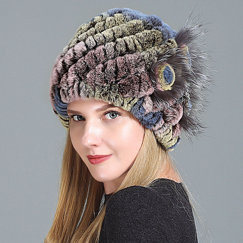 Womens Fur Knitted Hat in muted green, brown and pink tones with a decorative side flower.