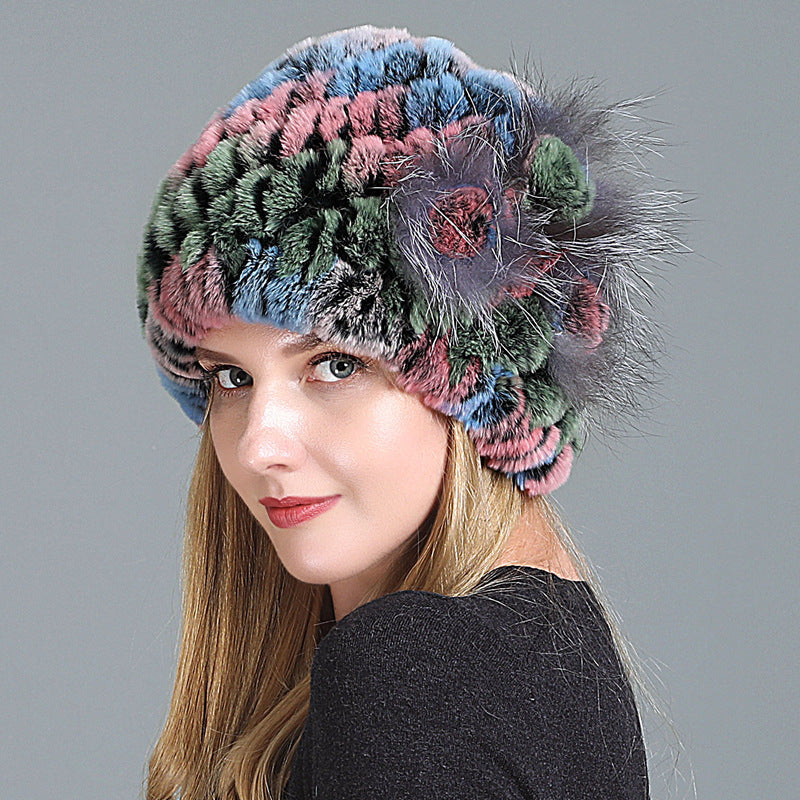 Womens Fur Knitted Hat in pink, blue and green tones with a grey decorative side flower.
