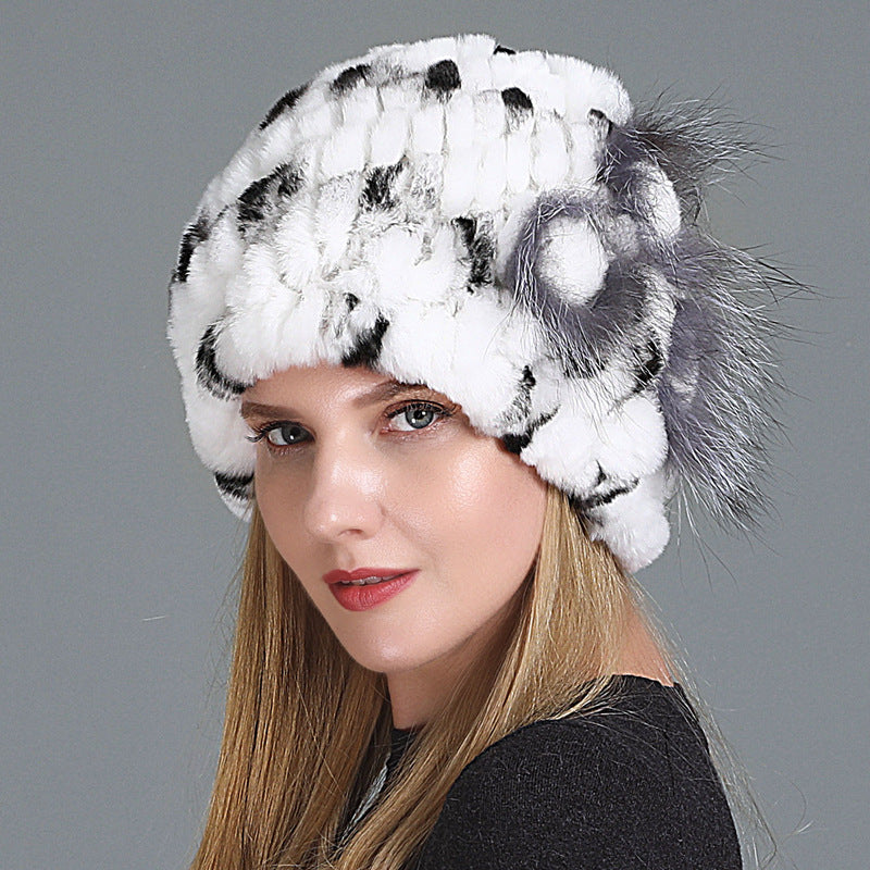 Womens Fur Knitted Hat in white with dark accents and a grey decorative side flower.