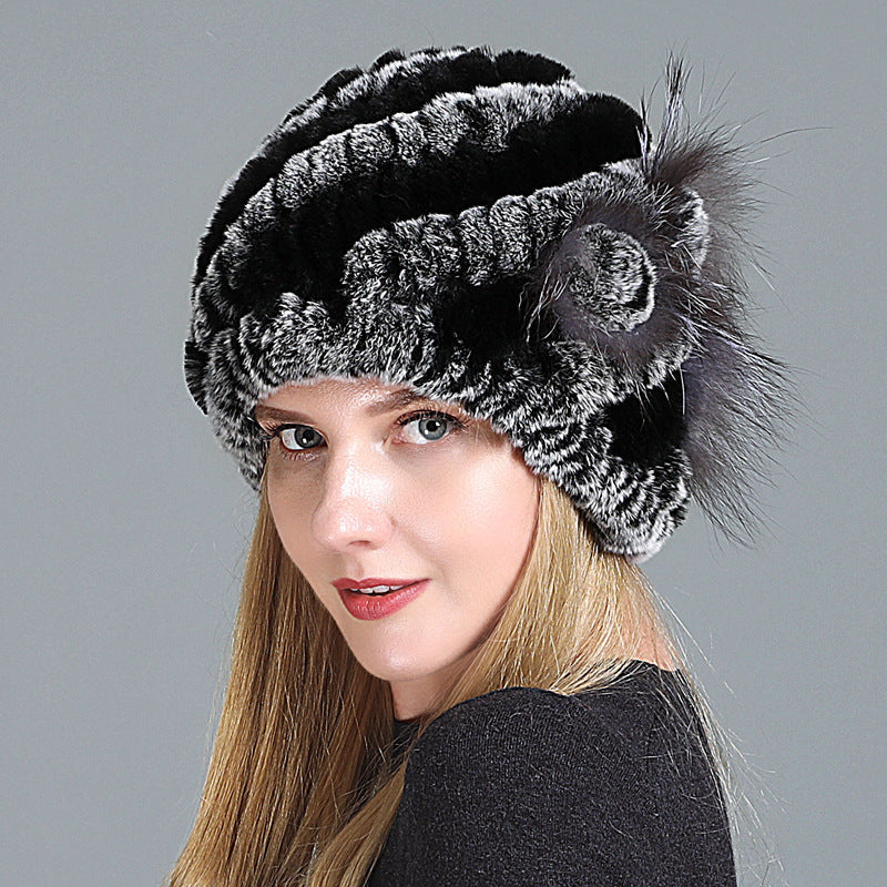 Womens Fur Knitted Hat with black and grey stripes, shown from an angled view with a side flower.