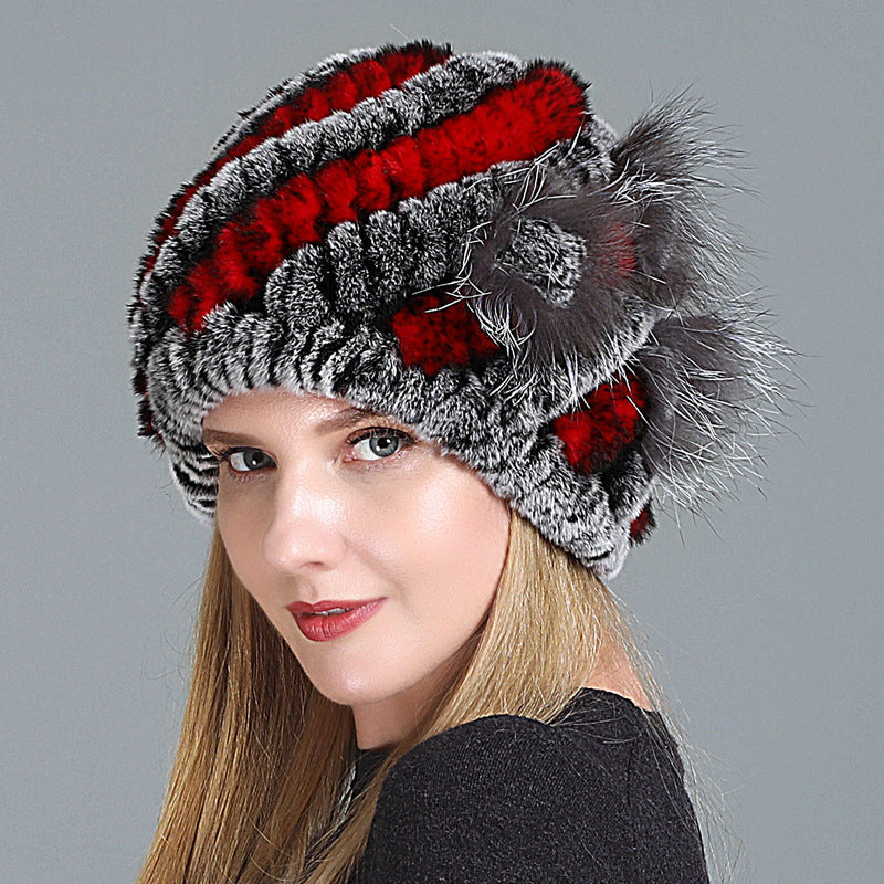 Womens Fur Knitted Hat with red and grey stripes, shown on a model from an angled view.