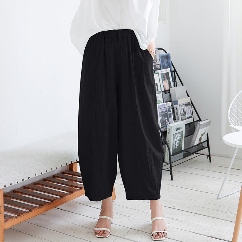 Womens Plus Size Lantern Trousers in black styled with a white top and casual shoes