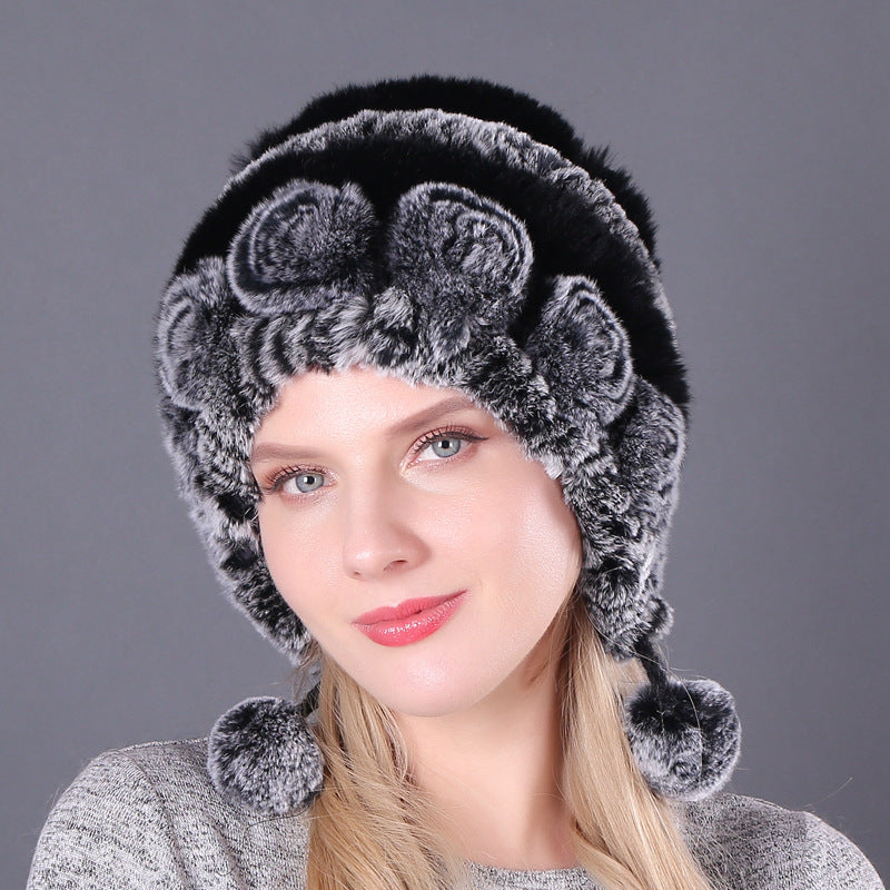 Womens Rabbit Fur Hat in black with grey accents, floral details and dark hanging pom-poms.
