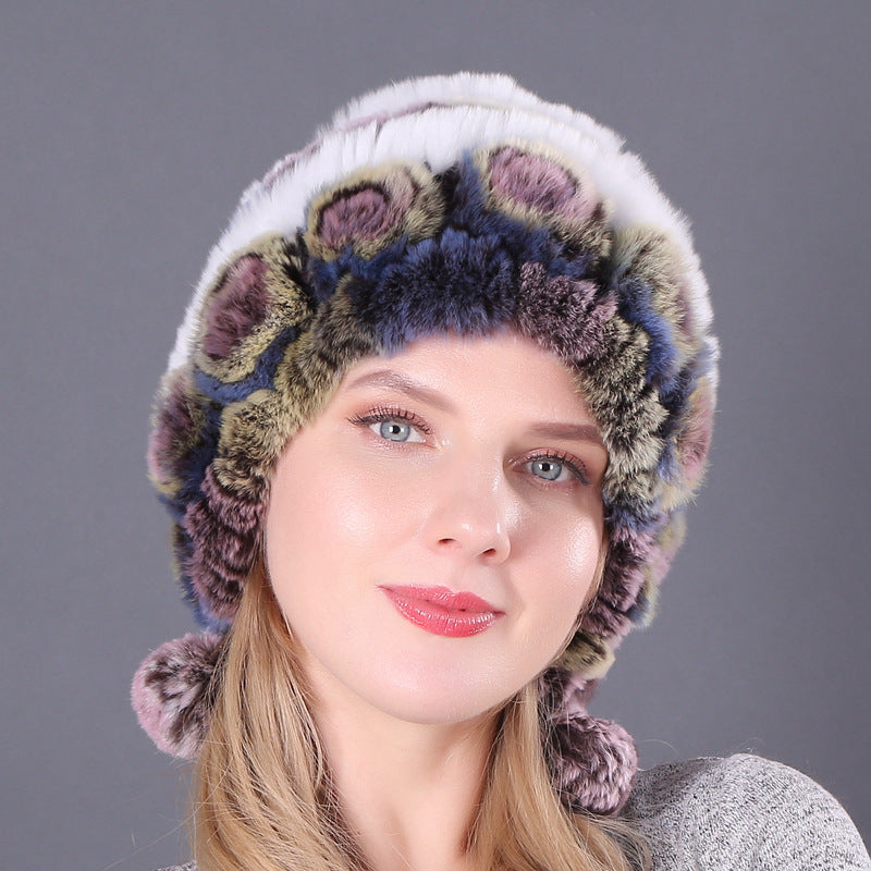 Womens Rabbit Fur Hat in muted green, pink and blue tones with white rows, floral details and hanging pom-poms.