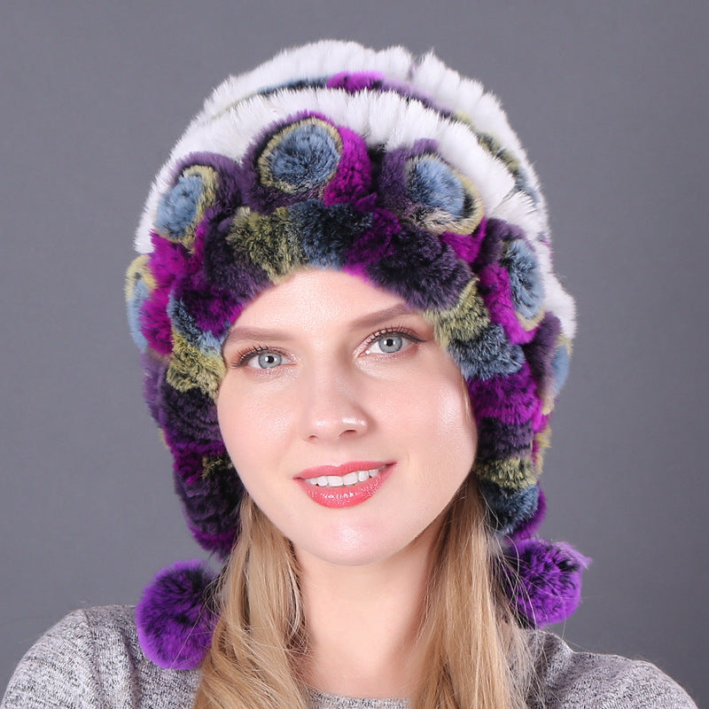 Womens Rabbit Fur Hat in white, purple and green tones with colourful floral details and purple hanging pom-poms.