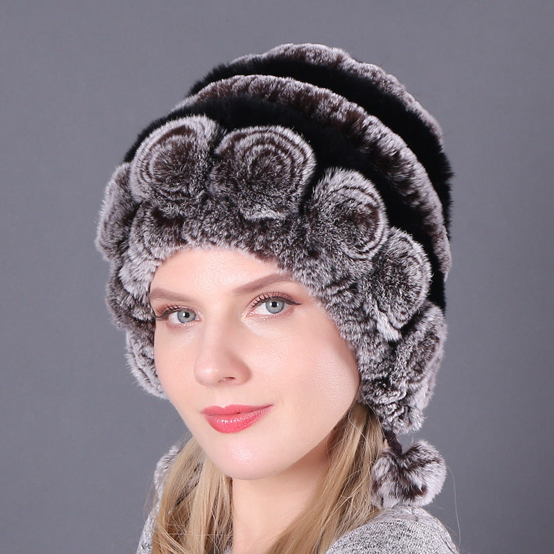 Womens Rabbit Fur Hat with black and grey stripes, grey floral details and hanging pom-poms.
