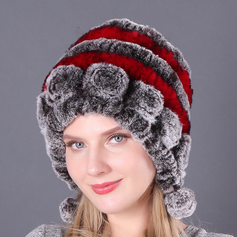 Womens Rabbit Fur Hat with red and grey stripes, grey floral details and hanging pom-poms, shown from the front.