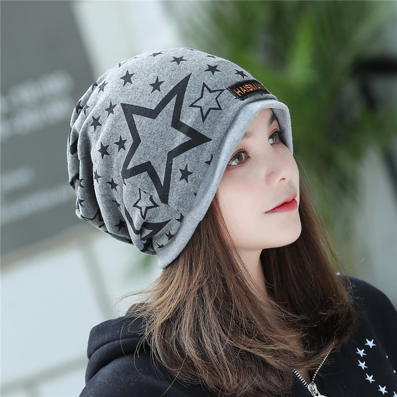 Womens Star Print Beanie in light grey with a large outlined black star, shown from an angled side view.