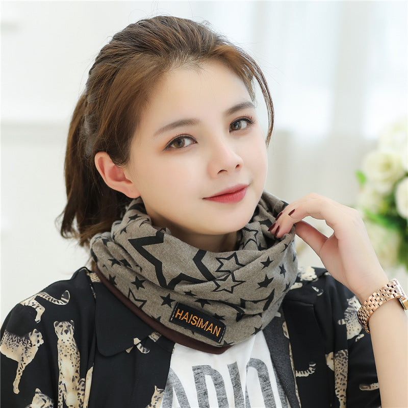 Womens Star Print Beanie in light grey with black stars, worn by a model with a patterned jacket.