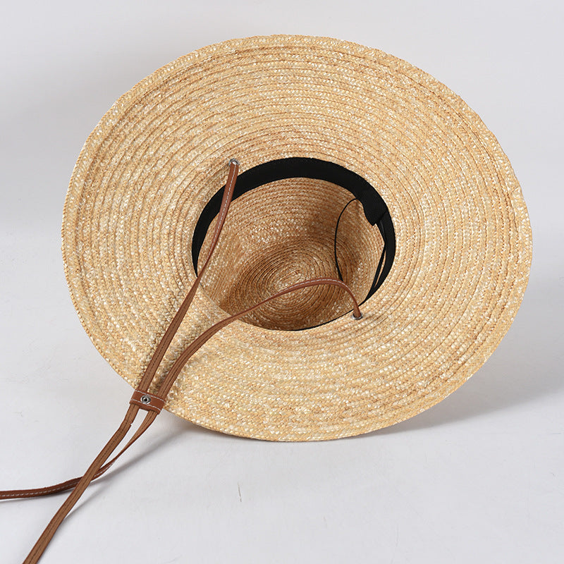 Womens Wide Brim Straw Hat viewed from underneath, showing the inner crown, dark inner band and brown strap.