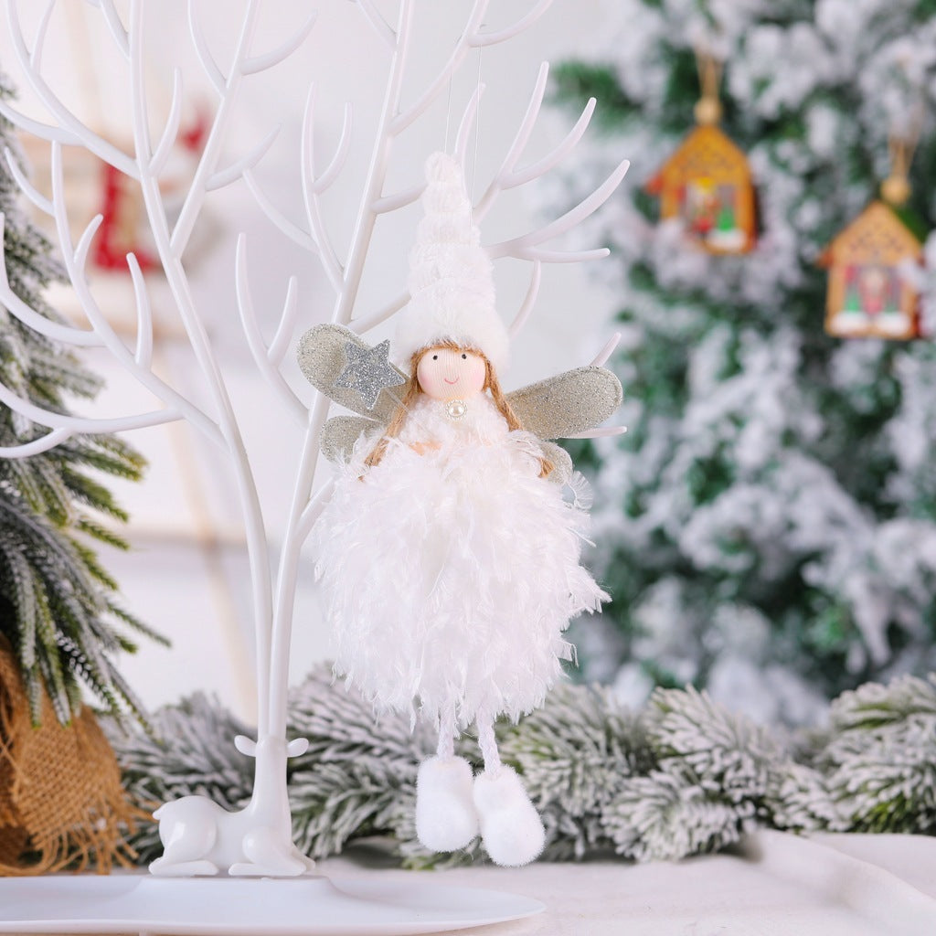 Christmas angel pendant with white dress and star on tree, festive decoration.