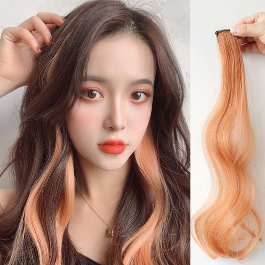 Curly Face-Framing Hair Extensions shown on model with warm orange highlights