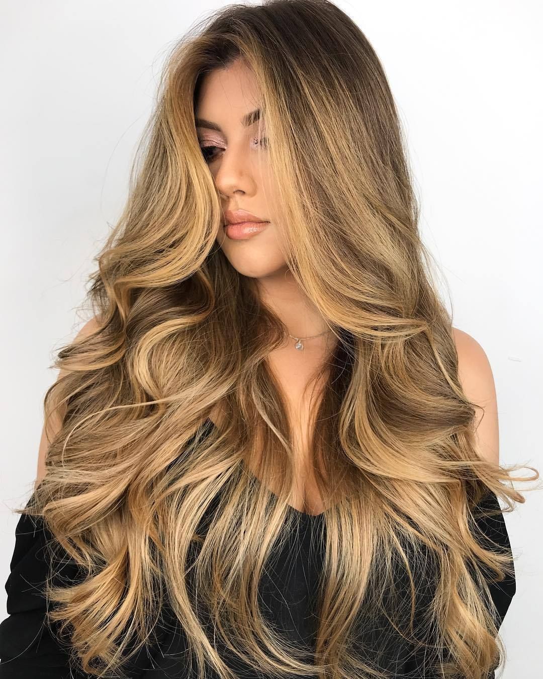 Fish Line Hair Extension in long blonde curls shown on model