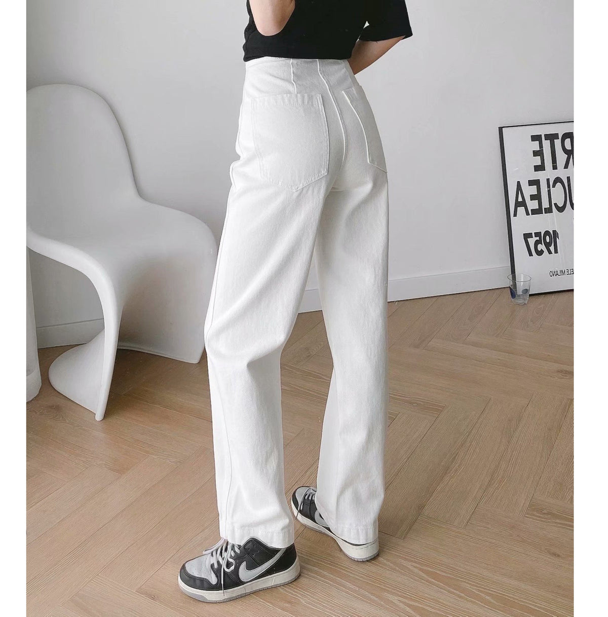 Womens Banana Pants in white shown from the side with a washed full-length design