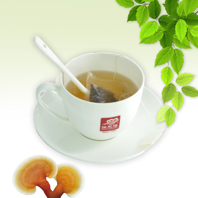 Reishi Green Tea sachet displayed with tea cup and green leaves